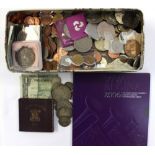 A box containing a collection of various coins, including a bag of various silver coins,