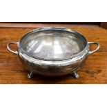 An early George VI silver soup tureen raised on three lion's paw and acanthus leaf feet,