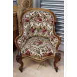 A mid Victorian walnut deep button backed armchair,