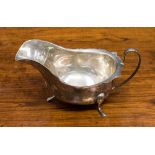 An Edward VIII silver sauce boat raised on three feet, fluted rim, Viner's Ltd, Sheffield 1936,