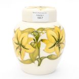 A cream ground Moorcroft ginger jar, having yellow flowers,