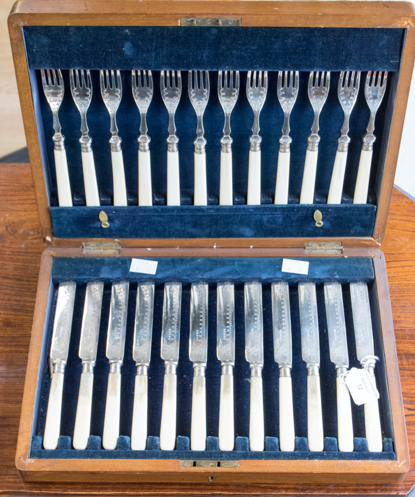 A canteen of Edwardian plated fruit knives and forks with ivory handles