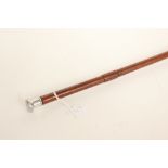 An unusual car tyre pressure guage in the form of a riding crop or Swagger stick.