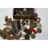 A collection of WW2 British cap badges,