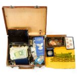 A collection of coins and banknotes in an attache case includes proof sets and Commemorative Crowns