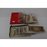 A bag of World Banknotes 180 plus with an album and bag containing a cigar band collection
