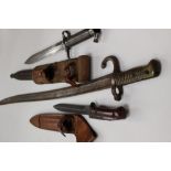Three bayonets: Swedish Mauser bayonet with scabbard and leather frog: French Chassepot bayonet (no