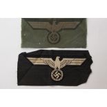 WW2 Third Reich Heer Bevo breast eagles: one in Feldgrau and one in Panzer black. Both unissued.