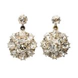 A pair of diamond flower head cluster white gold drop earrings,