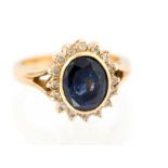 A sapphire and diamond oval cluster 18ct yellow gold ring,