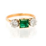 An emerald and diamond three stone 18ct gold ring,