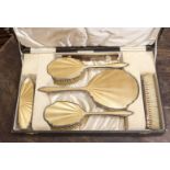 A cased silver and enamel dressing table set, Birmingham 1936,