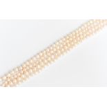 A string of knotted cultured pearls,