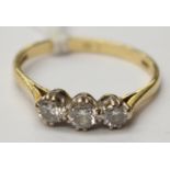 An 18ct gold ring with three diamonds, size N with a total gross weight 2.