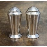 A pair of George V Art Deco silver salt and pepper pots, Birmingham 1933, of inverted conical form,