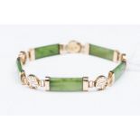 A jadeite curved bar link 14ct gold bracelet with Chinese symbol yellow gold spacers and a snap