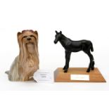 A Beswick Yorkshire Terrier with raised paw and hair bow,