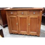 An early 20th Century teak and pitch pine dresser, the upper section with five spice drawers,