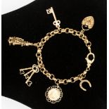 A 9ct yellow gold charm bracelet, suspending four various 9ct charms,
