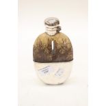 A snakeskin hip flask with glass bottle