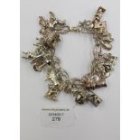 A white metal charm bracelet with numerous Continental charms,