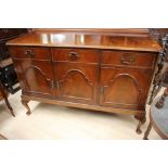 A Georgian style mahogany sideboard, fitted with three drawers and three doors,