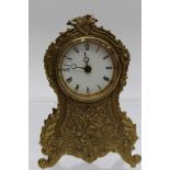 A French gilt metal mantle clock, enamel dial with Roman numerals, verso glass covered aperture,