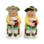 A pair of 19th Century Staffordshire pottery beer drinking Toby jugs, each with tricorn hat lids,