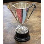 A silver handled trophy on black detachable metal stand, the trophy alone weighing approx 6.