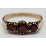 A possibly 9ct gold 19th century ring set with three garnets, size Q with a total gross weight 2.