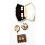 A silver locket, silver brooch with glazed compartment to reverse,