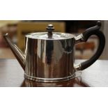 A George III English Provincial silver drum silver teapot, cylindrical form with ebony handle,