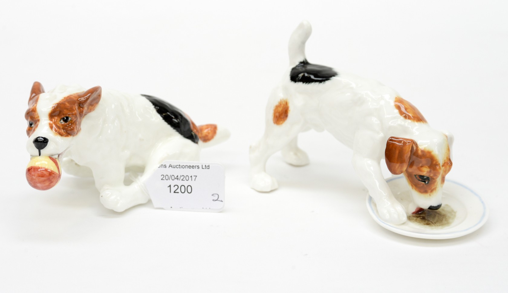 Two Royal Doulton terriers, one with ball,