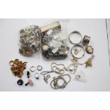 A bag of costume jewellery and badges, a bag of rings, etc including brooches,