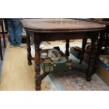 An early 20th Century oak draw-leaf dining table,