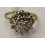 A 9ct gold ring set with nineteen diamonds in a cluster style,