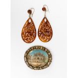 A pair of early 20th Century carved tortoiseshell pendant earrings of pierced pear drop shape,