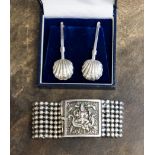 A pair of white metal napkin or bib clasps and an Indian silver bracelet, marked 0.