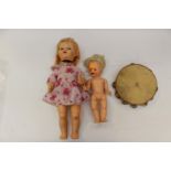 Two Pedigree dolls, and a pig skin tambourine; together with two jigsaws,