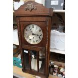 An oak drop dial wall clock (key and pendulum)