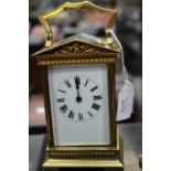 A French carriage timepiece, early 20th Century, brass portico corniche case, enamel Roman dial,