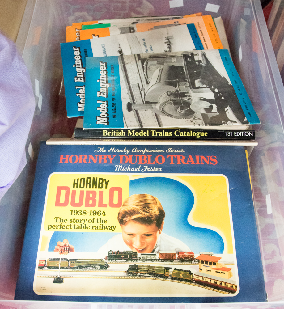 A box containing books and magazines relating to model railway: three books from the Hornby