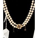 A cased double strand Ciro cultured pearl necklace with gold clasp,
