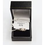 An Art Deco solitaire diamond platinum ring with diamond set shoulders,