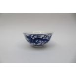 A Chinese blue and white tea bowl, decorated with dragons amongst clouds, everted rim,