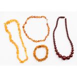 A string of cherry amber beads and two strings of polished Baltic amber and a bracelet (4)