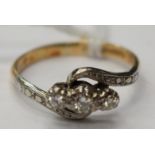 An 18ct gold twist ring with three diamonds size M with a total gross weight 2.