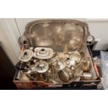 A box containing a collection of various silver plated teawares, comprising two tea services,