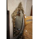 A Baroque style large gilt metal mirror