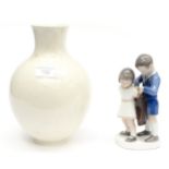 A Royal Copenhagen cream baluster vase together with a figurine of a girl and boy (R-Copenhagen)